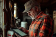 © Dzmitry - Farmer reviewing crop health data on tablet in rustic barn setting