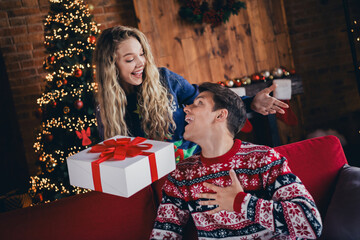 Wall Mural - Photo of lovely young couple amazed shocked receive gift dressed christmas outfit day light home party decoration interior room