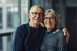 © Markus Schröder - Portrait of a grinning couple in their 60s sporting a breathable mesh jersey in front of sophisticated corporate office background