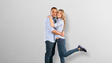 Happy young couple man and woman standing and posing