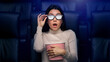 © Prostock-studio - Scared Asian woman in 3D glasses watching horror movie in cinema