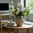 © Hasbi - A Serene and minimalist living room with a focus on natural elements, holding a vase filled with blooming flower blossoms and a stack of books