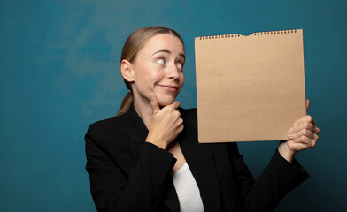 Wall Mural - young blonde woman with a paper notebook