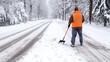 © DELstudio - Worker Clearing Snow from Road with Shovel in Winter. Urban Maintenance and Safety