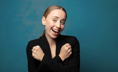 Wall Mural - smiling cheerfully and celebrating, with fists clenched and arms crossed, feeling happy and positive