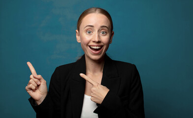 Wall Mural - feeling joyful and surprised, smiling with a shocked expression and pointing to the side