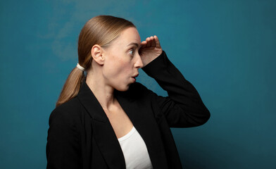 Wall Mural - looking bewildered and astonished, with hand over forehead looking far away, watching or searching