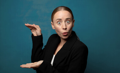 Wall Mural - feeling joyful and surprised, smiling with a shocked expression and holding something