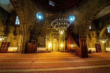 Wall Mural - Erzurum Grand Mosque, Interior view of the mosque built of stone. Grand Mosque with its ornate chandelier and stone walls.