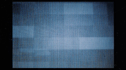 close-up of the screen texture of an old VHS video tape, with a blue color dot background and a grainy film effect. Photo overlay via blend mode.