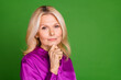 © deagreez - Photo portrait of lovely pensioner lady look minded camera dressed stylish purple satin garment isolated on green color background