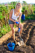 © JackF - Female gardener digging in garden with spade