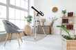 © Pixel-Shot - Interior of living room with grey armchair, houseplants and modern telescope near window