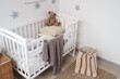 © Pixel-Shot - Interior of light children's bedroom with crib, toy stars and teddy bear