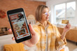 © Pixel-Shot - Young woman with mobile phone and credit card shopping online at home on autumn day, closeup