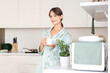 © Pixel-Shot - Young woman with cup of coffee in kitchen