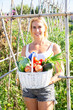 © JackF - Smiling young blonde holding freshly harvested vegetables grown in her home garden .