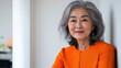 © Aris - Korean senior business woman standing at office after budget meeting