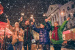 © deagreez - Photo of full family four member x-mas meeting gathering hold bengal stick walk wave raise hands magic miracle generation outerwear hat scarf coat evening street illumination outside