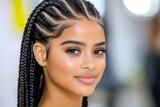 A creative African American hairstylist braiding intricate patterns in a clientâ€™s hair at a trendy salon