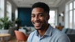 © VistaVisions - Smiling cheerful young adult african american ethnicity man in casual attire looking at camera standing at home office background. Happy confident black guy headshot face front close up portrait