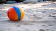 © Yeivaz - Colorful Beach Ball on Sandy Shore