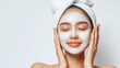 © WS Studio 1985 - Young Woman Enjoying a Relaxing Facial Treatment with White Mask on Her Face, Looking Peaceful and Rejuvenated in Spa-Like Environment