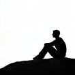 © Boinah - A silhouette of a person sitting contemplatively on a hill against a bright background.