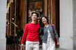 © bongkarn - A lovely, sweet young Asian couple are walking out of a retail store together, enjoying a shopping.