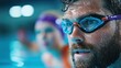 © DKPhoto - An intense underwater portrait of a male swimmer showcasing his determination and focus, with droplets glistening, evoking emotions of athleticism and competitive spirit.
