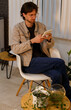 © ADDICTIVE STOCK - Man relaxing and reading in a cozy modern living space
