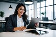 © Michael - Young Latina Entrepreneur Innovating on Tablet in Trendy Workspace