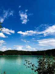 Scenic lake view under a vibrant blue summer sky