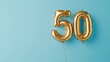 © ryanbagoez - Banner with number 50 golden balloon with copy space. thirty years anniversary celebration concept on a blue background
