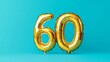© Pangestu - Banner with number 60 golden balloon with copy space. thirty years anniversary celebration concept on a blue background