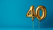 © Pangestu - Banner with number 40 golden balloon with copy space. thirty years anniversary celebration concept on a blue background