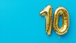© Pangestu - Banner with number 10 golden balloon with copy space. thirty years anniversary celebration concept on a blue background