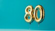 © Pangestu - Banner with number 80 golden balloon with copy space. thirty years anniversary celebration concept on a blue background