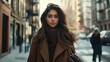 © Svfotoroom - A young woman strides purposefully through a lively city street, wearing a stylish outfit that reflects the autumn season