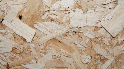 Aufkleber - close up view of textured fiberboard surface, showcasing its natural wood pattern and rough texture. image highlights intricate details and varied shades of material