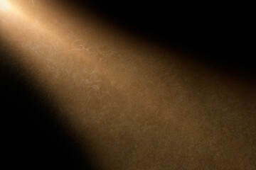 Wall Mural - orange spotlight effect on stage or crepuscular rays or gods rays with particles isolated on black b