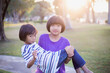 © chaunpis - Cute children play in the park at sunset.