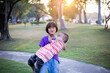 © chaunpis - Cute children play in the park at sunset.