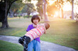 © chaunpis - Cute children play in the park at sunset.
