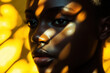 © Steven - Close-up of a young Black woman with natural lighting casting artistic shadows on her face, highlighting her serene expression against a warm golden background.