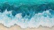 © Seyyar - Aerial view of textured saltwater waves gently crashing onto a sandy beach, showcasing a gradient of vibrant blue shades in the clear sea, creating a serene panoramic landscape.
