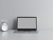 © PuriStudio - A close-up shot of a sleek modern laptop resting on a smooth, matte grey background, background, concept