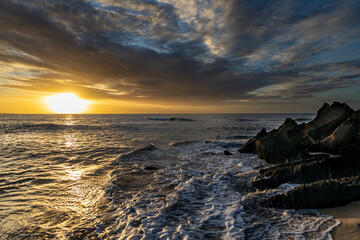 Golden colored sea waves during sunset. Sunset at sea.