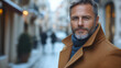 © Hanna - Stylish Man in Brown Coat standing on a city street in autumn