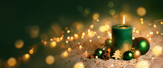 Wall Mural - burning christmas advent candle - green candle with xmas decoration and magic golden lights - christ